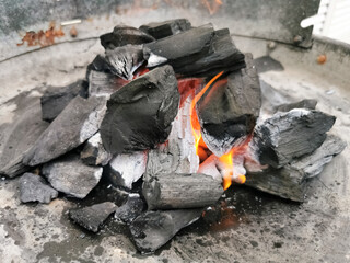 Macro view of burning coal embers bonfire, detail of coal texture