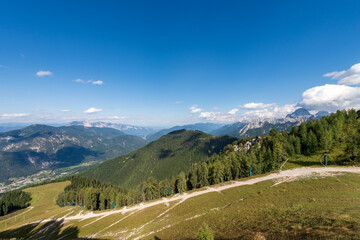 The Julian Alps seen from the Monte Lussari with the small village of Camporosso in Valcanale, Val Canale Valley, Tarvisio, Friuli Venezia Giulia, Italy. On the horizon the Peak of the Mount Mangart.