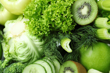 Fototapeta na wymiar Fresh green vegetables on whole background, close up