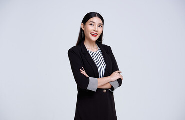 Smiling Confident Asian business woman over gray background.