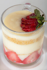 jar of strawberry pudding magnolia desert over white backdrop
