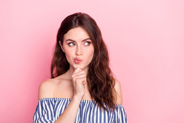 Photo of nice optimistic brunette lady hand chin look empty space wear blue dress isolated on pastel pink color background