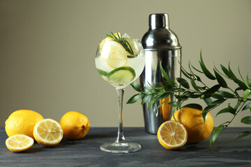 Glass of cocktail with citrus on dark table