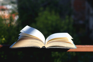 Open book in a garden. Selective focus.
