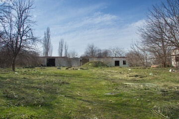 Ruins of an abandoned concrete house overgrown with trees in a forest in southern Russia, Krasnodar