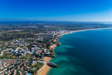 Fototapeta premium Aerial view of the scenic Algarve coastline, with beaches and resorts; Concept for summer vacations in Portugal