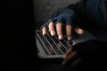 hacker hand stealing data from laptop top down 