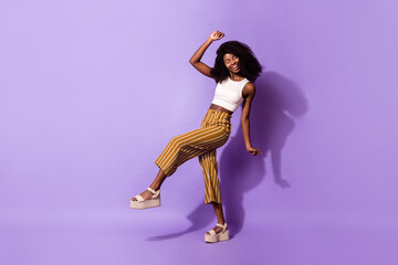 Full length body size view of charming dreamy cheerful girl having fun moving isolated over bright violet purple color background