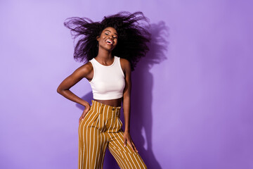 Portrait of attractive cheerful content girl air blowing hair good mood clubbing isolated over bright violet purple color background
