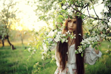 Cherry blossoming garden in spring beautiful adult young girl relaxing