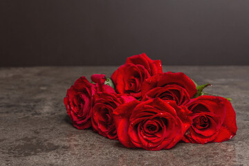 Bouquet of fresh red roses on marble background