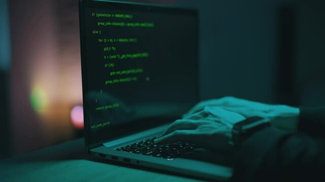 Close up of developing programming and coding technologies. Programmer hands are typing on keyboard. Software coder or blockchain developer at night. Concept of bitcoin cryptocurrency and wallet hack