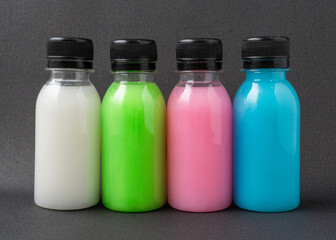 Colorful liquid in a bottles on black background.