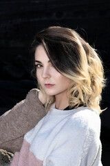 portrait of young woman in a wool sweater outdoors