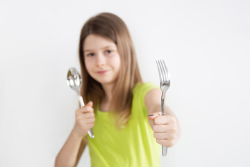 Girl with spoon and fork isolated on the white background