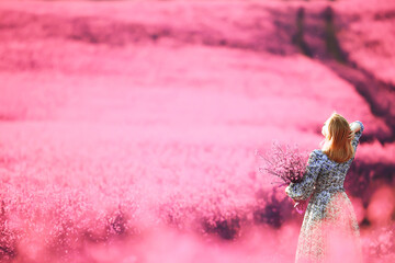 girl in a field of lilac flowers in lavender colors, violet and pink landscape, happy and harmony