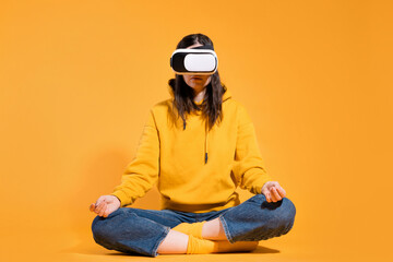 Immersion in cyberspace, virtual reality and the user. A gamer in a yellow hoodie and with a VR helmet