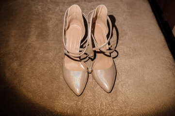 Beautiful diamond ring on women's shoes. Close-up. Wedding accessories