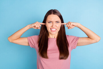 Photo of angry mad unhappy young woman avoid close ears fingers bad mood isolated on blue color background