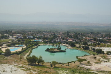 Fototapeta na wymiar Landscape from to Natural travertine pools and terraces in Pamukkale. Cotton castle in southwestern Turkey. View to mountains landscape