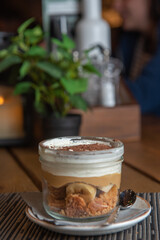 Tiramisu with banana in transparent glass