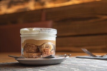 Tiramisu with banana in transparent glass