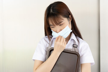 Catering business worker wearing face mask becoming sick, infected by COVID-19 coronavirus or...