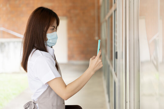 Asian Woman Restaurant Worker Scanning Code For Checking In Her Workplace, Contact Tracing Concept