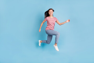 Fototapeta na wymiar Full body profile side photo of stunning happy young woman jump up run isolated on blue color background