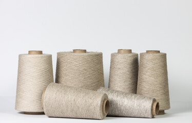linen thread for sewing, wound on a wooden spool, vintage, on a white background