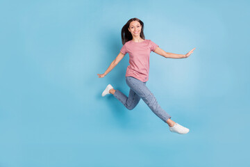 Fototapeta na wymiar Full body profile side photo of happy nice pretty lady jump up air go empty space isolated on blue color background