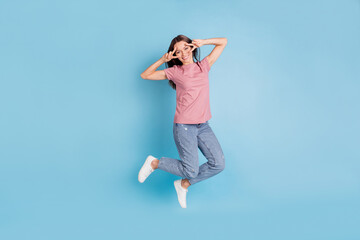 Full body photo of happy charming lady jump up make hands v-signs isolated on pastel blue color background