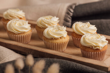 Tasty cupcakes on wood stand