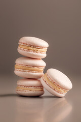 Desserts. Pastry, bakery and branding concept - French macaroons on cream beige background, parisian chic cafe dessert, sweet food and cake macaron for luxury confectionery brand