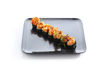 Gunkan Sushi - Gunkan Maki Sushi with Seafood and Spicy Sauce. Sushi with Rice inside and wrapped nori seaweed around. Delicious Gunkan Sushi on black slate plate. Isolated on white background.