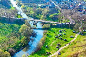 Picnic in village Trebujeni from Moldova . Aerial view of rural area and people on the riverside 