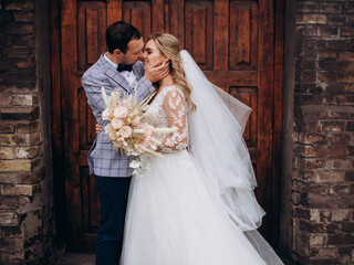 Beautiful newlywed couple near old catholic church