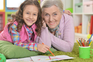 Fototapeta premium grandmother and granddaughter drawing together