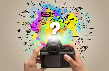 Close-up of a hand holding digital camera with abstract drawing concept