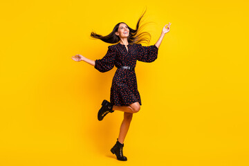 Fototapeta na wymiar Full length body size view of attractive cheerful girl dancing having fun good mood isolated over bright yellow color background