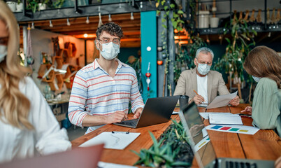 Group of people working in office during Covid-19