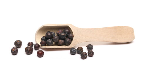 Dried juniper berries with wooden spoon isolated on white background