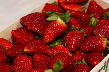 A crate of red strawberries fruit from farm