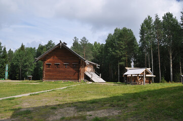 Old wooden houses from a bar in a clearing in the middle of the forest. 03 August 2020, Malye Korely, Arkhangelsk, Russia