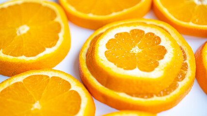 Naklejka na ściany i meble Sliced orange with perfect structure and skin. Juicy orange-white background with oranges. Ripe Spanish orange