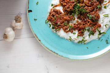 Turkish Sauteed Lamb Meat Served with Smoked Eggplant and Yogurt Puree, Garnished with Grilled Hot Pepper. Ali Nazik Kebab