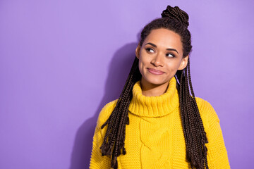 Photo of optimistic brunette girl look empty space wear yellow sweater isolated on purple color background