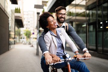 Young couple having fun in the city and ride a bicycle