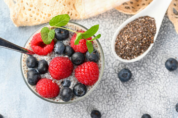 Healthy chia pudding with coconut milk and fresh berry in a glass