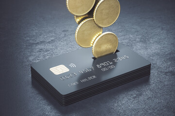 Cashback loyalty programm concept with metal coins bound for a stack of black credit cards on abstract dark surface